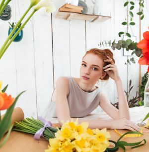 tired-young-woman-florist-gazing-at-camera-while-P6K7PK7.jpg